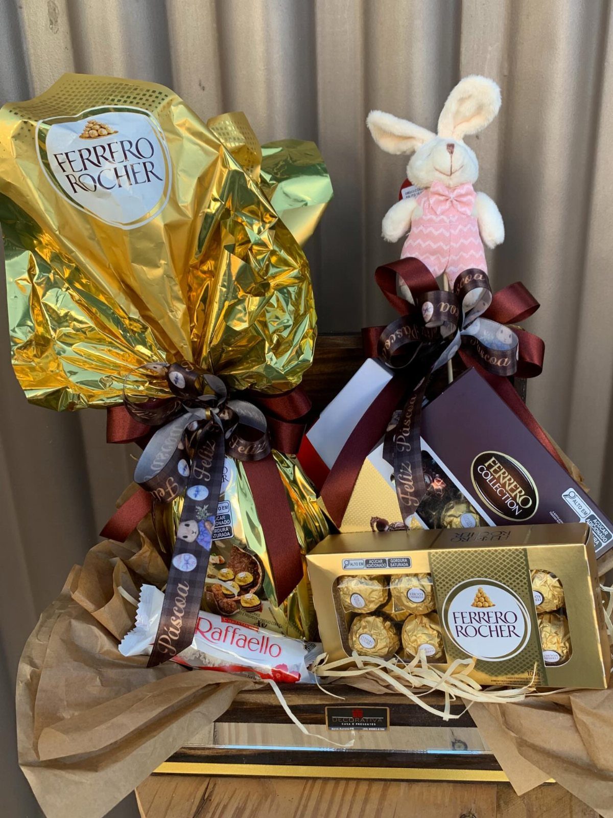 Gift basket with Ferrero Rocher chocolates and a small white plush bunny rabbit.