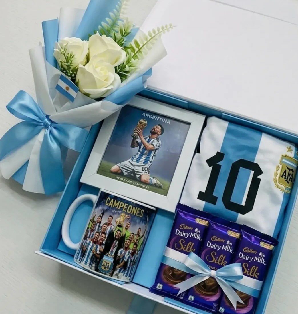 Argentina football themed gift box with jersey, Messi photo, mug, and chocolates.