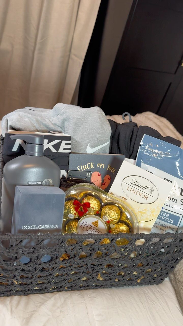 Grey woven gift basket filled with Nike apparel, chocolates, and grooming products.