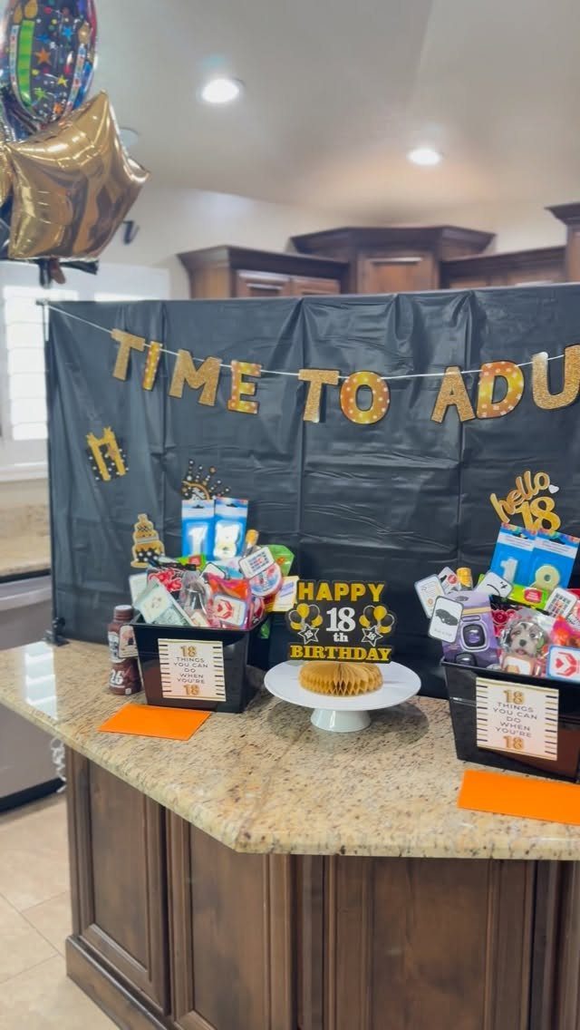 Two black birthday gift baskets and a cake for an 18th birthday celebration.