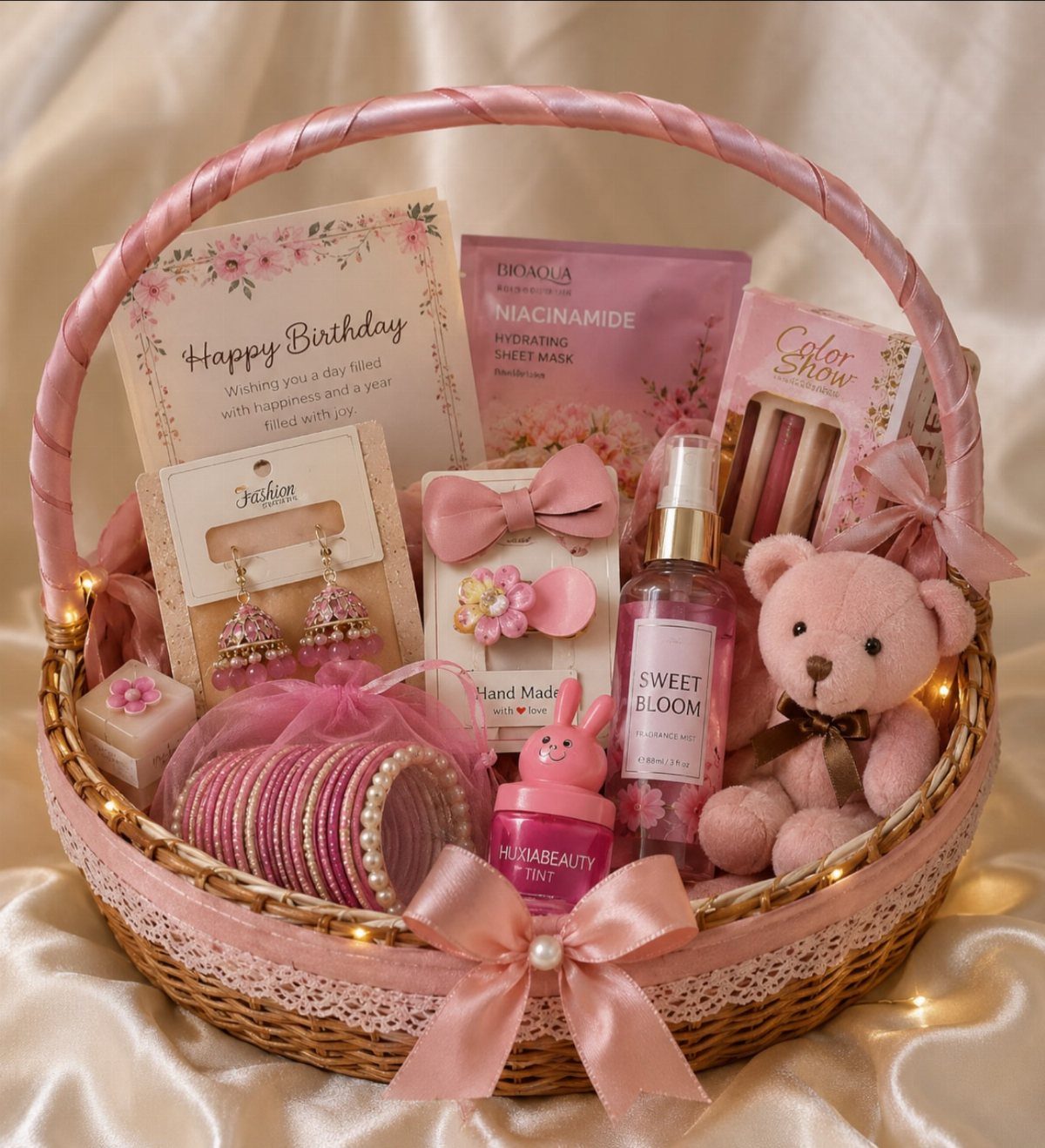 Pink birthday gift basket containing a teddy bear, jewelry, skincare, and a birthday card.