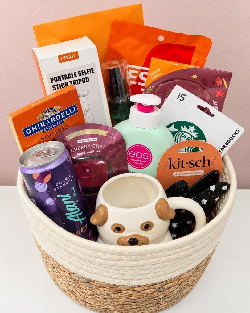 Gift basket with dog mug, Starbucks card, chocolates, and colorful treats for Halloween.