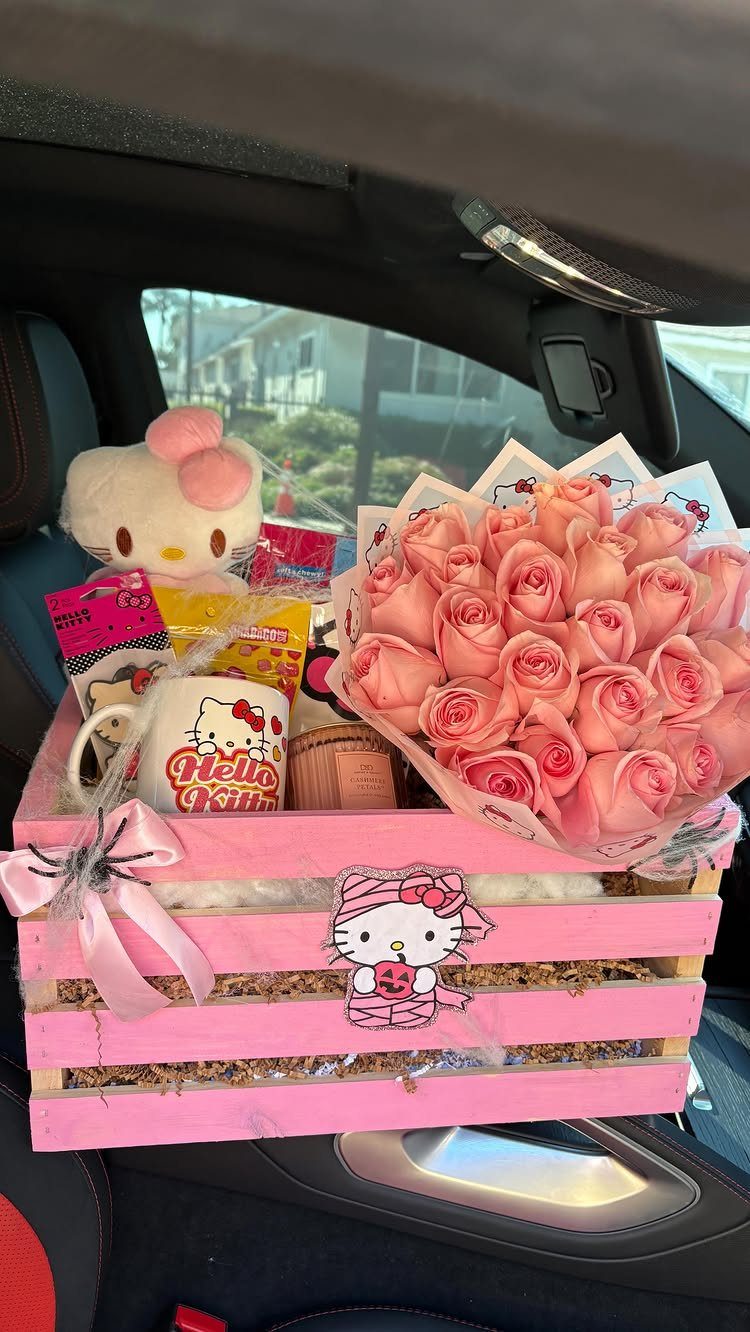 Pink wooden gift crate with Hello Kitty items and a bouquet of pink roses.