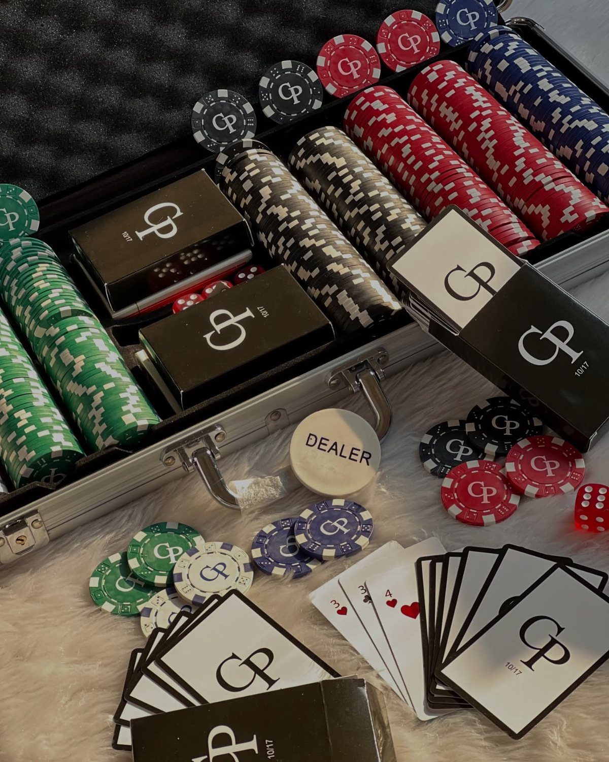 Personalized poker set with colorful chips and custom card decks in a silver case.