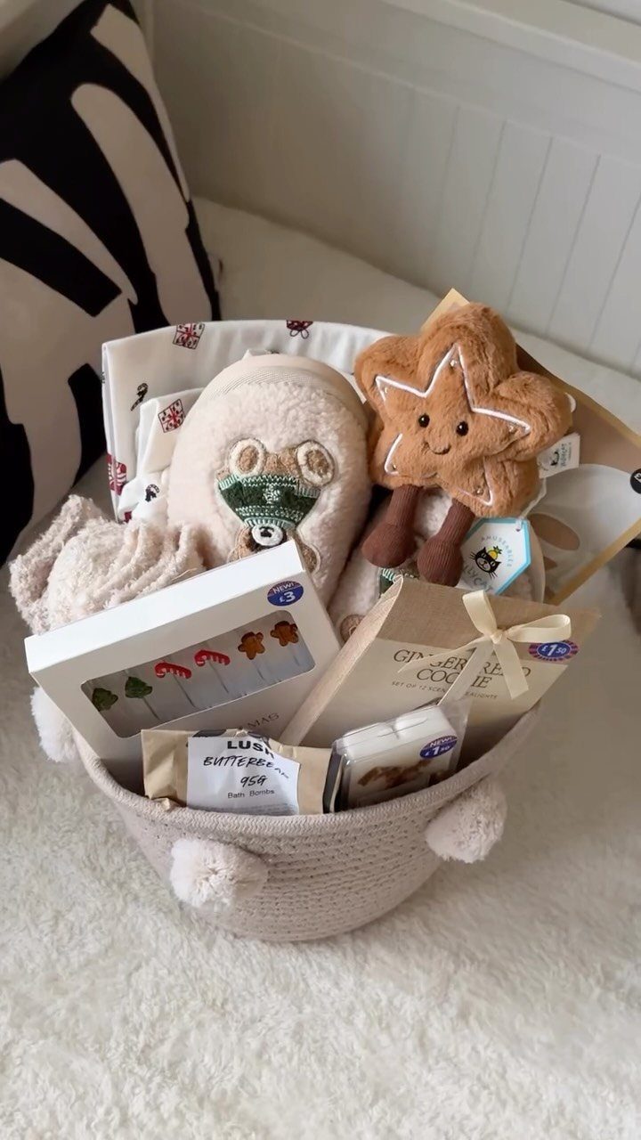 Gift basket with star plush, candy box, and cozy items on white rug