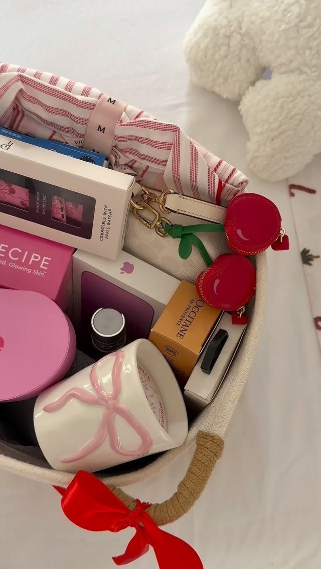Gift basket with beauty products, a white mug, and a red bow.
