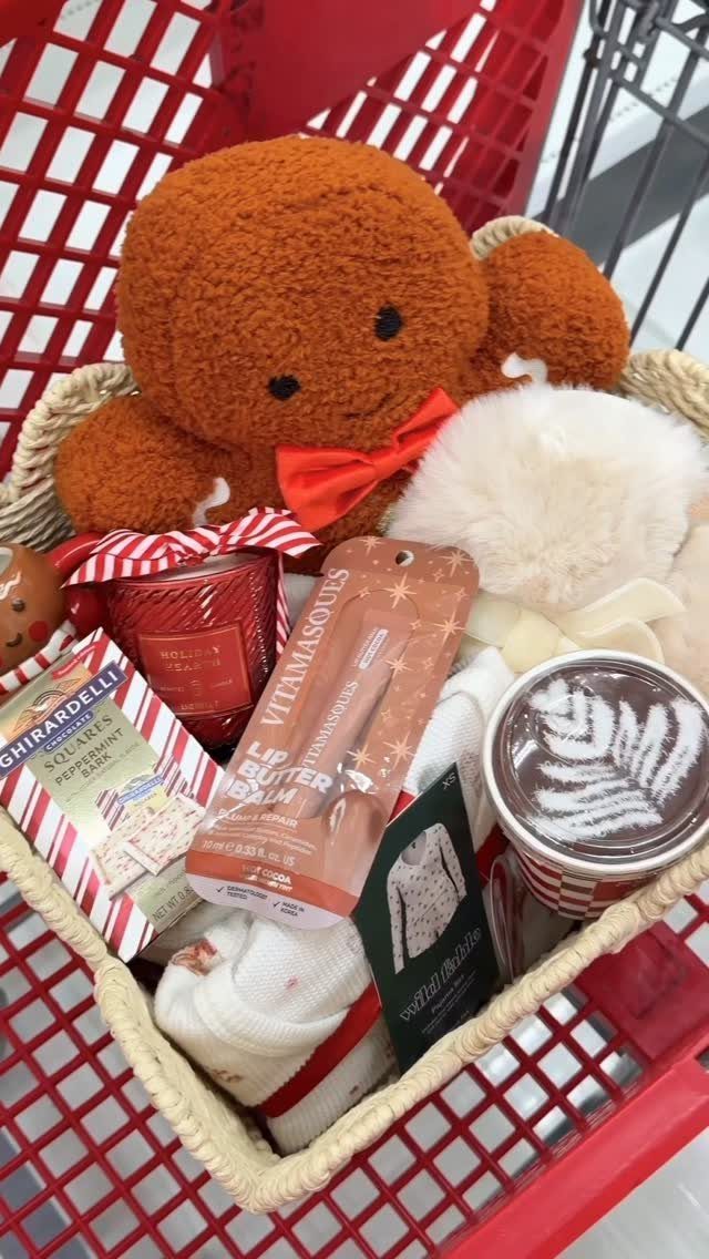 Gift basket with brown teddy bear, red candle, and sweets in red cart