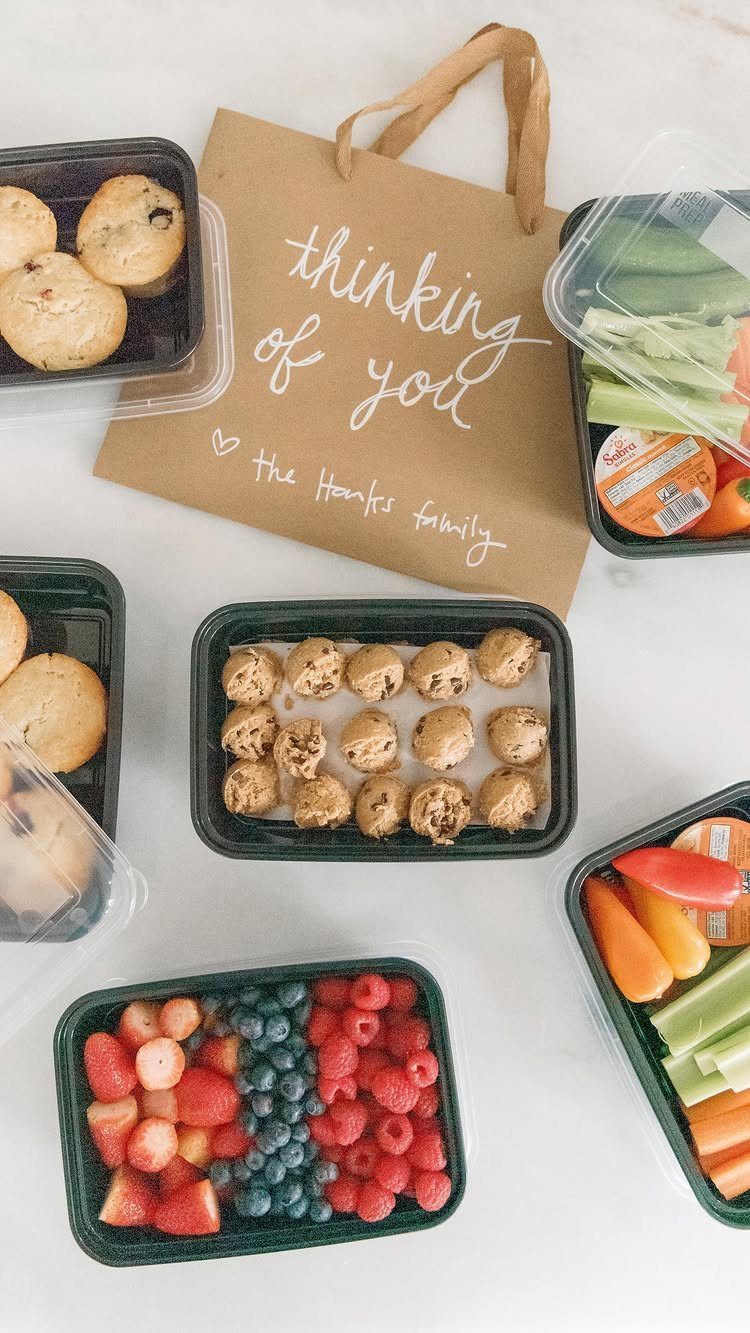 Meal prep containers with healthy snacks and a thinking of you gift bag.