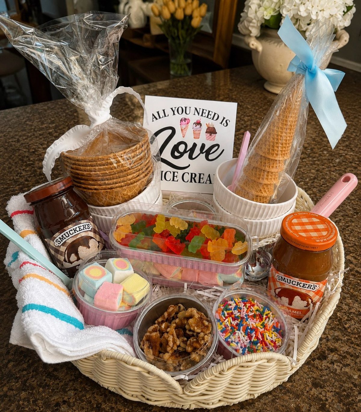 Ice cream gift basket with waffle cones, toppings, sauces, and a themed sign.
