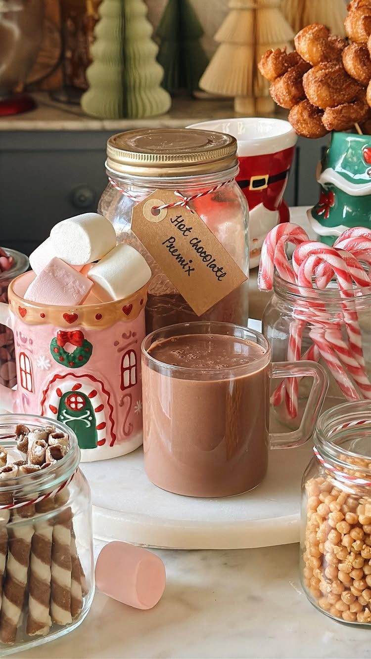 Hot chocolate premix in a jar next to a mug of cocoa and marshmallows.