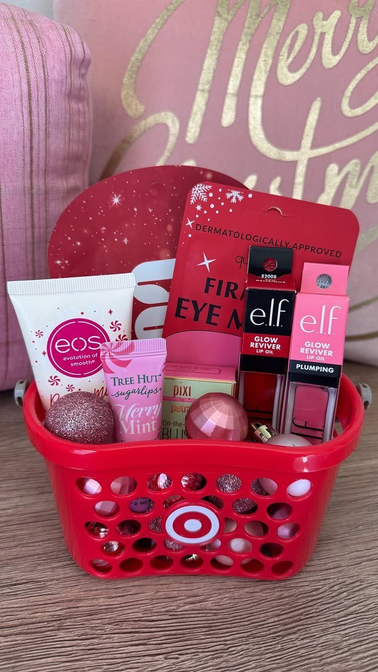 Red shopping basket filled with beauty products and lip glosses for a gift.