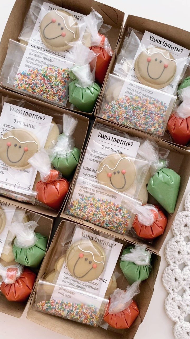 Cookie decorating kits in cardboard boxes with gingerbread cookies, sprinkles, and candies.