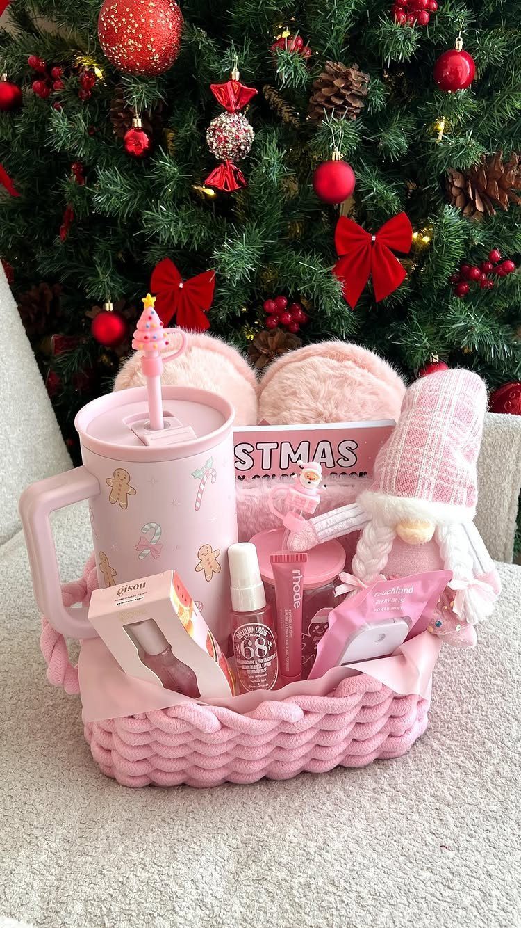 Pink knitted gift basket with nail polish and slippers before a Christmas tree