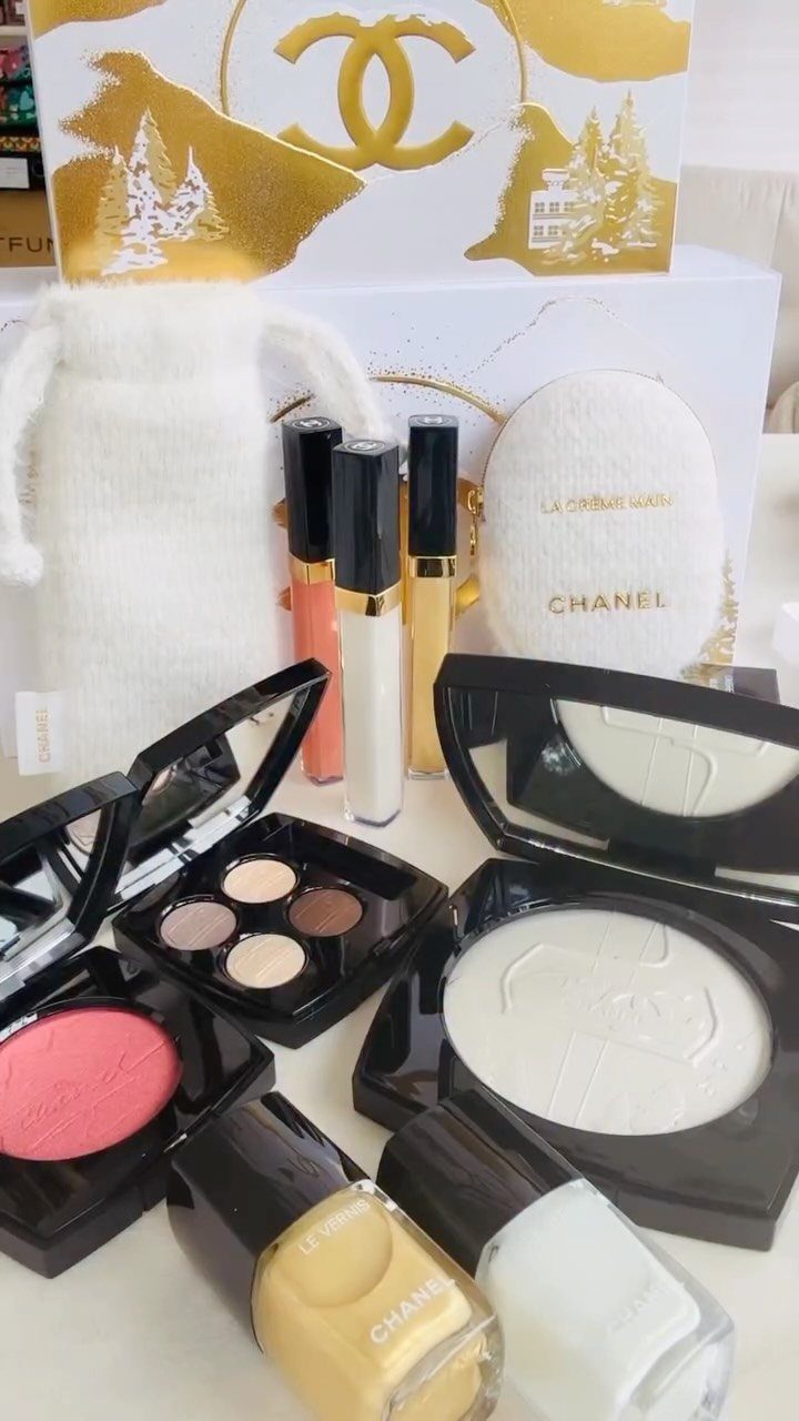 Chanel beauty products and a white fuzzy pouch arranged for a gift set