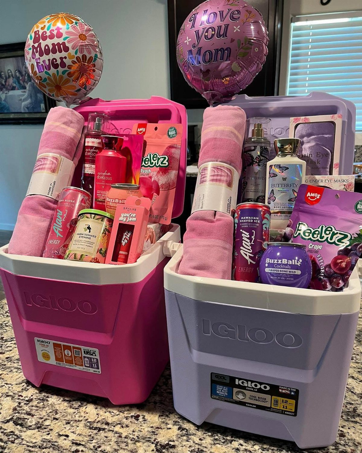 Pink and purple Igloo coolers filled with spa products and Mother's Day balloons.
