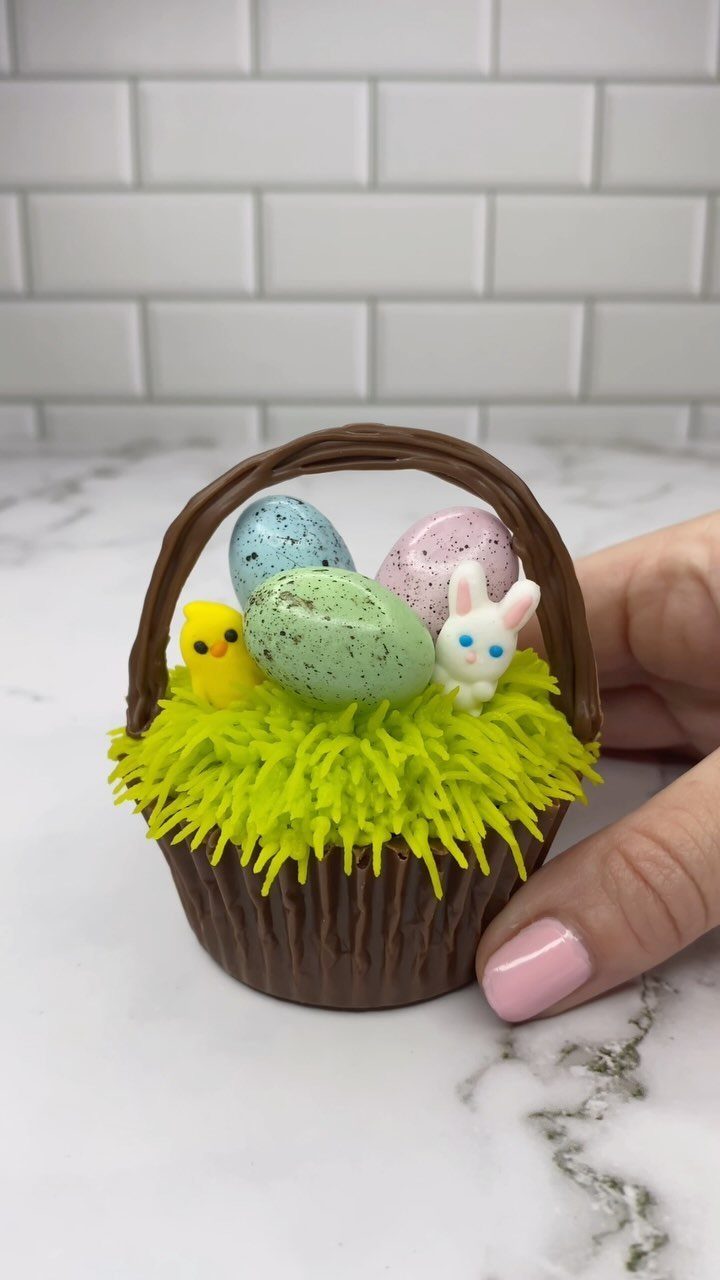 Chocolate Easter basket filled with speckled eggs, a chick, and a bunny figure.