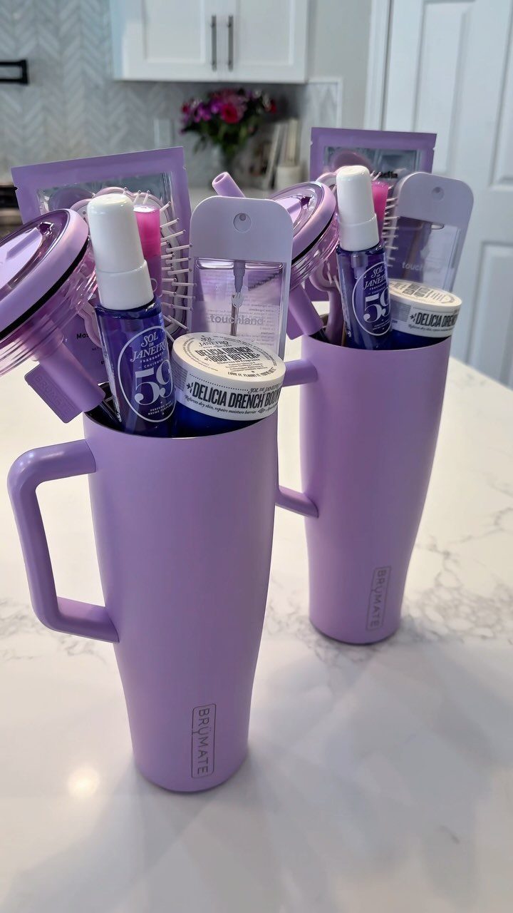 Two purple insulated tumblers filled with beauty products as creative Easter baskets.