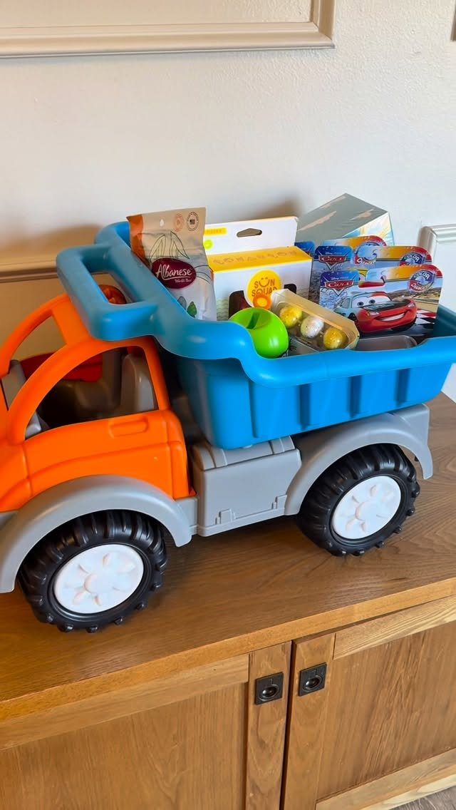 Toy dump truck used as an Easter basket filled with toys and treats.
