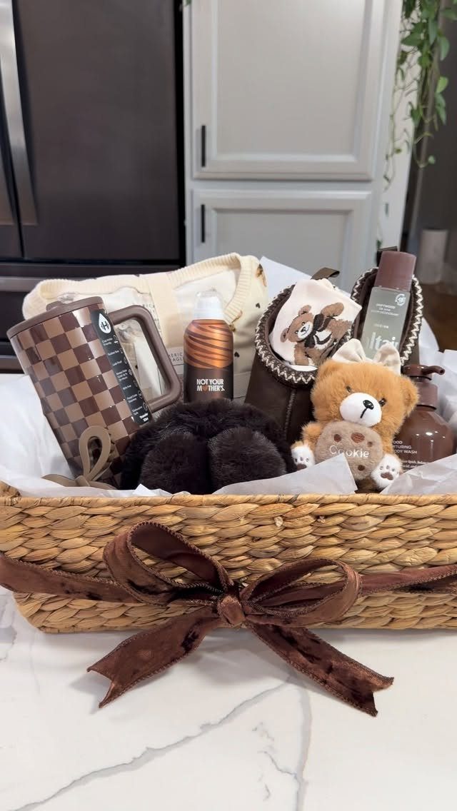 Woven gift basket with brown ribbon containing a teddy bear and skincare products.