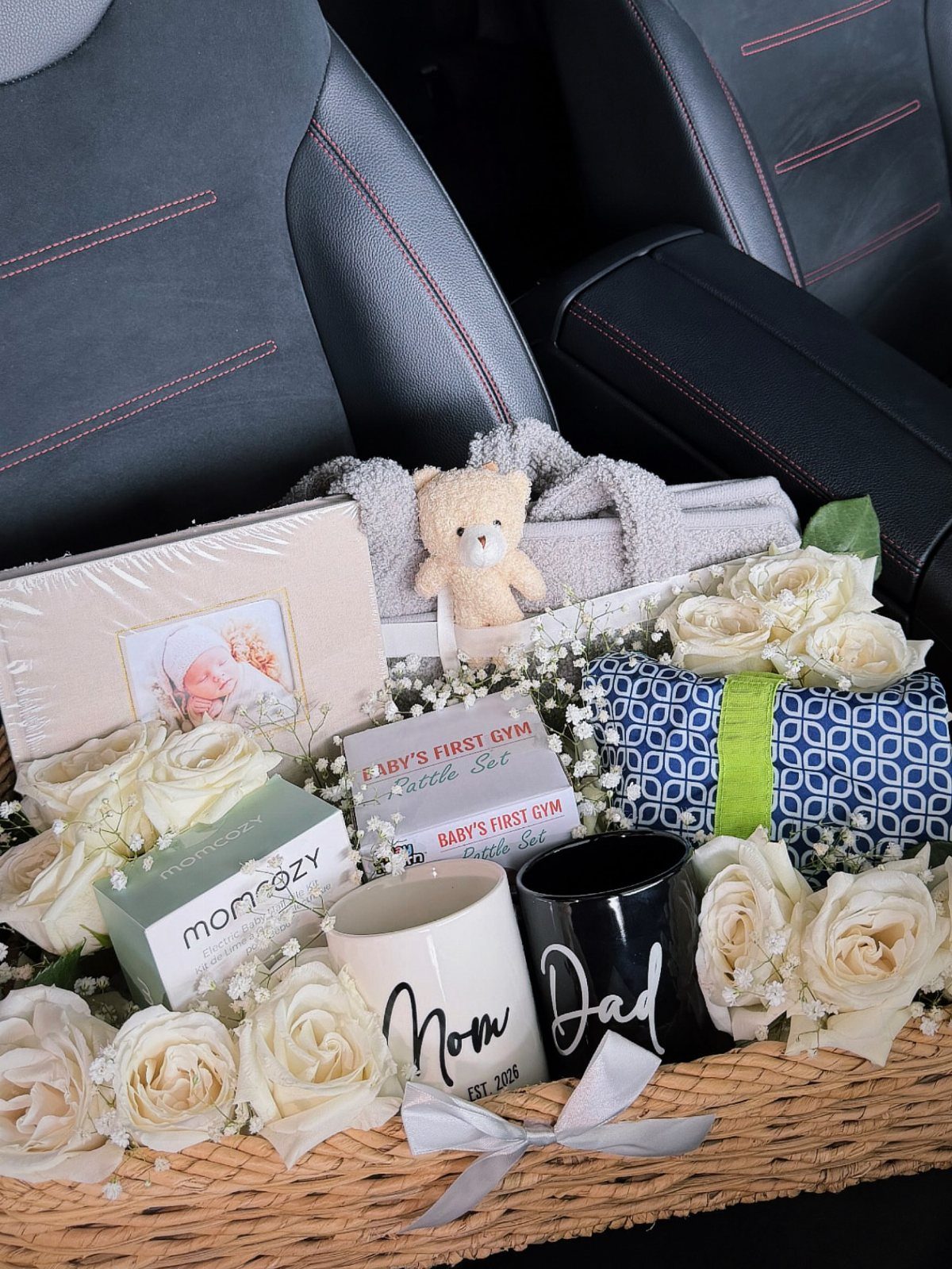 Wicker gift basket with Mom and Dad mugs, white roses, and a teddy bear.