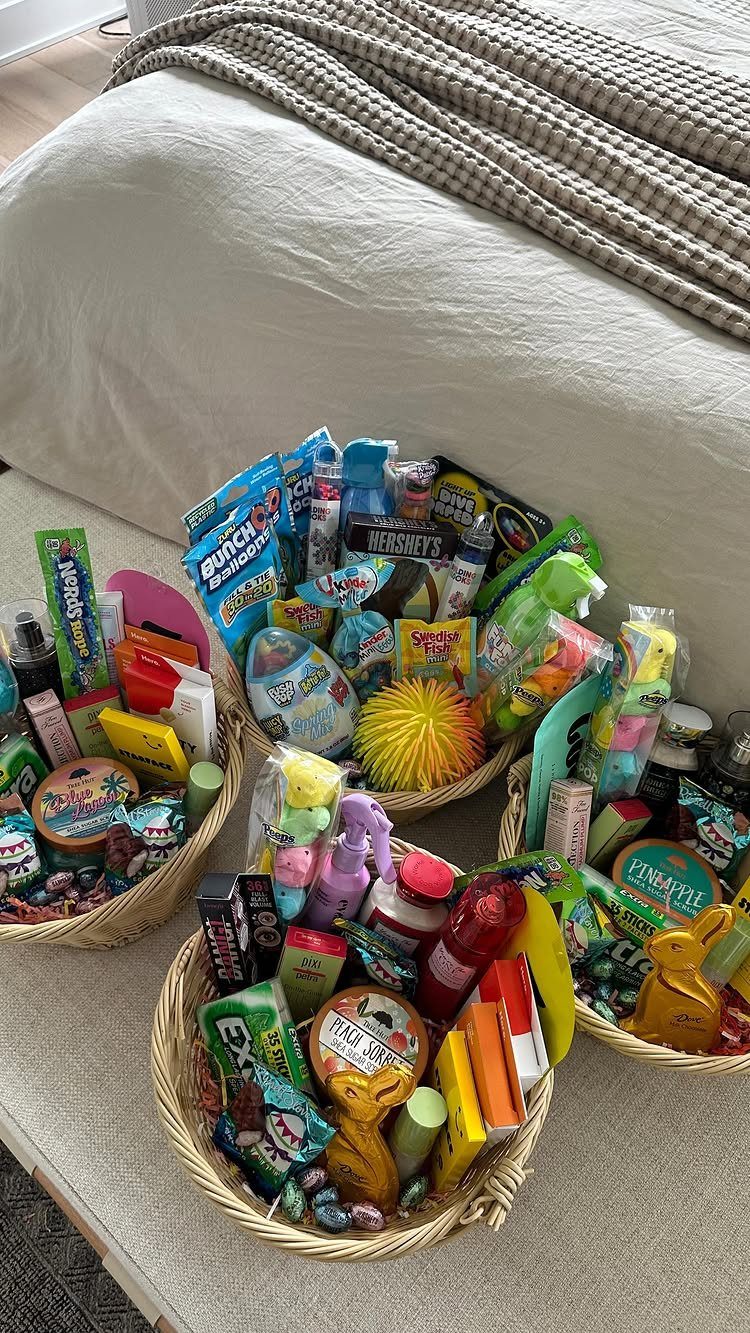 Woven wicker baskets filled with colorful candies and toys on a neutral rug.