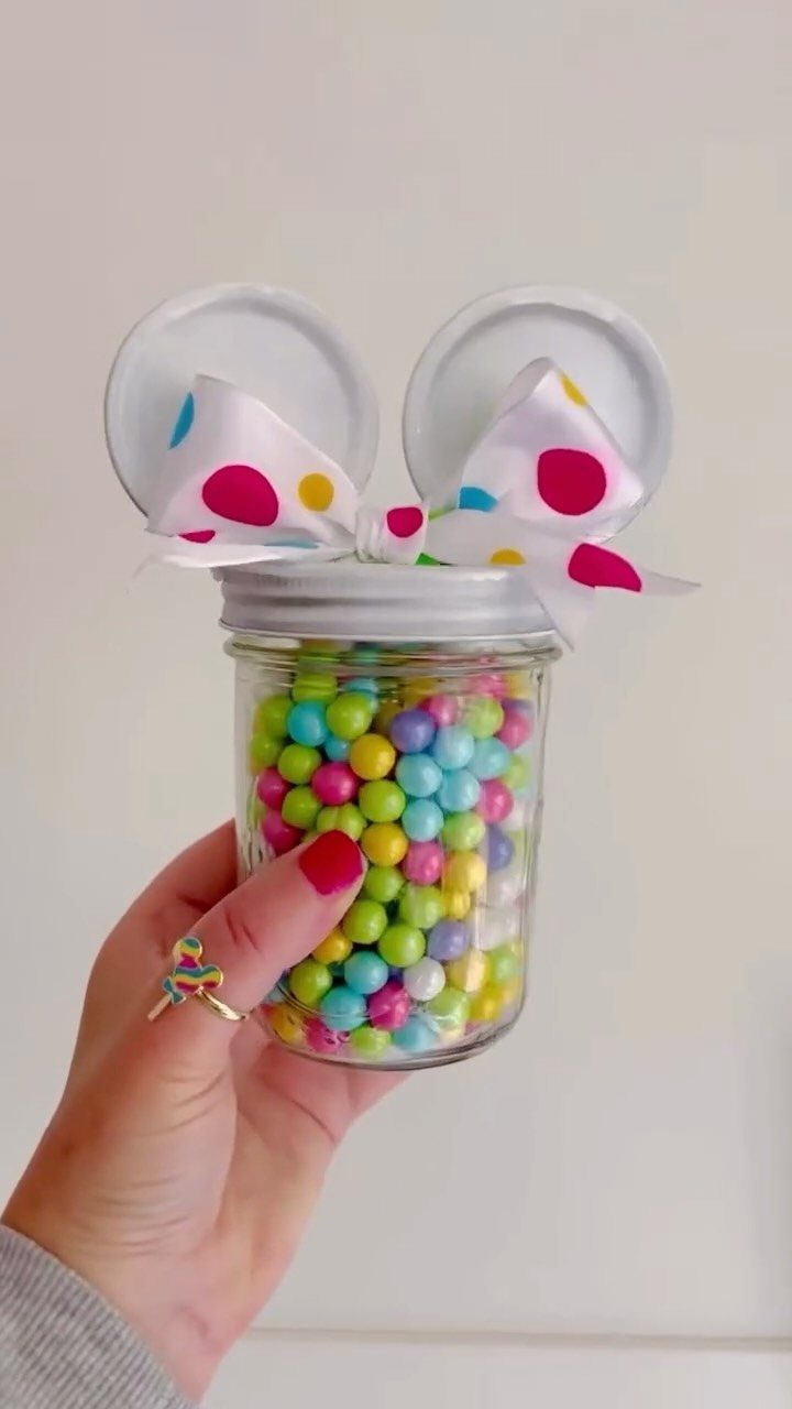 Mini mason jar filled with pastel candies and bunny ear decorations on top.