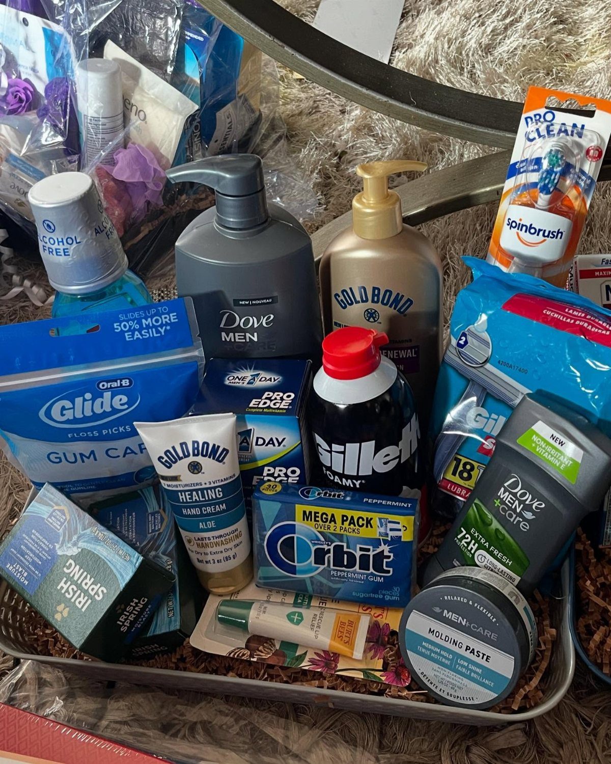 Men's grooming gift basket with Dove, Gold Bond, and Gillette hygiene products in a tray.