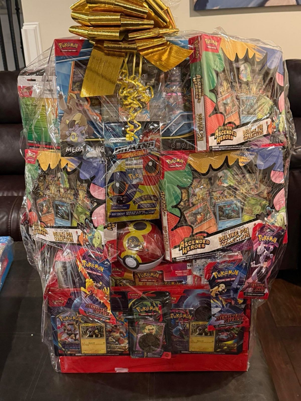 Pokemon themed gift basket filled with trading cards and a Poke Ball