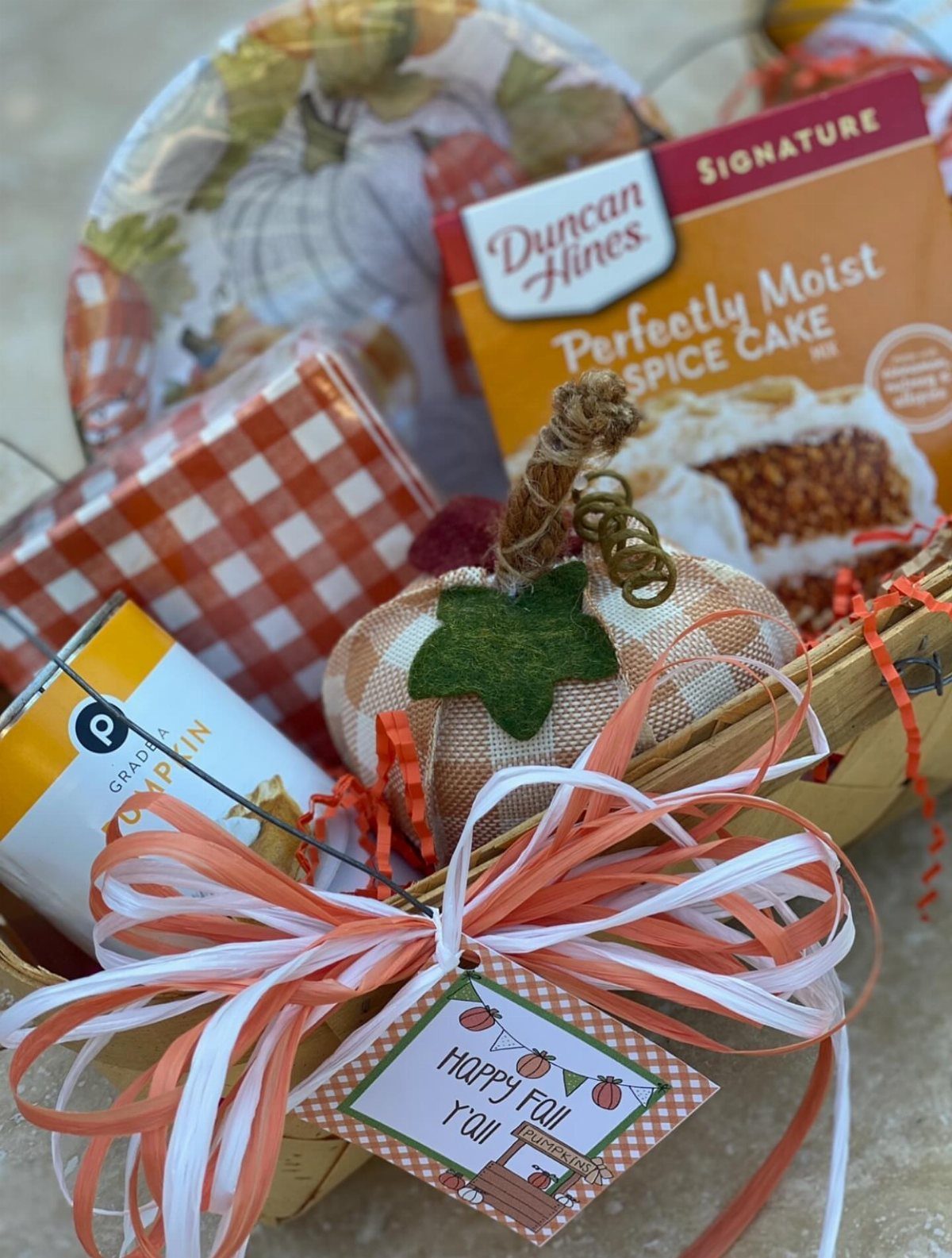 Autumn gift basket with spice cake mix, fabric pumpkin, and festive ribbons.
