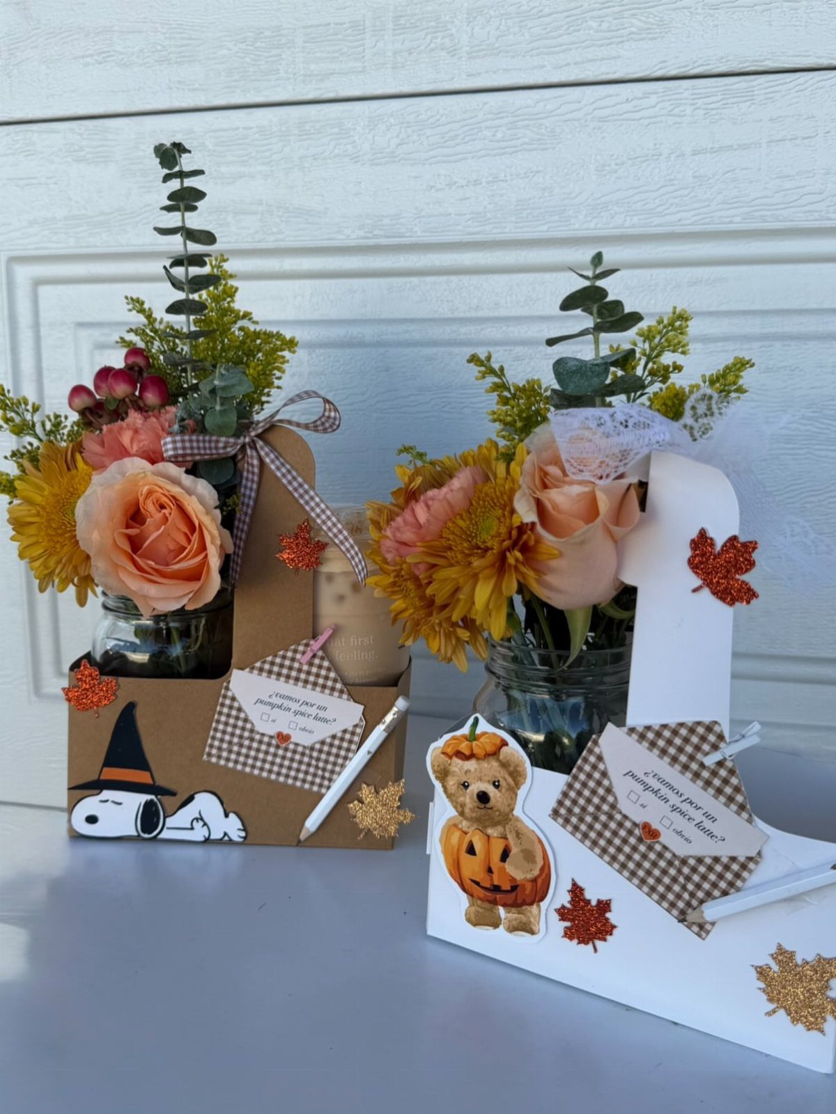 Two autumn-themed gift baskets with orange flowers, cards, and cute character illustrations.