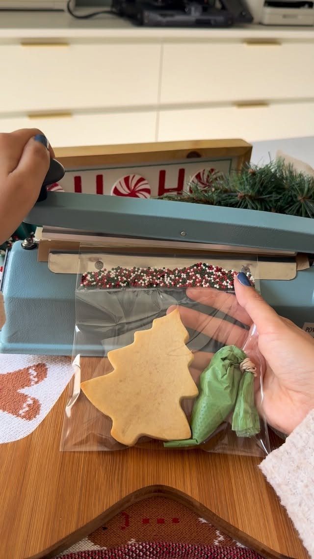 Tree-shaped cookie and green frosting in a bag for a decorating kit.