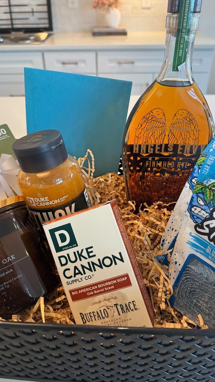 Gift basket for father containing bourbon, Duke Cannon soap, honey, and blue socks.