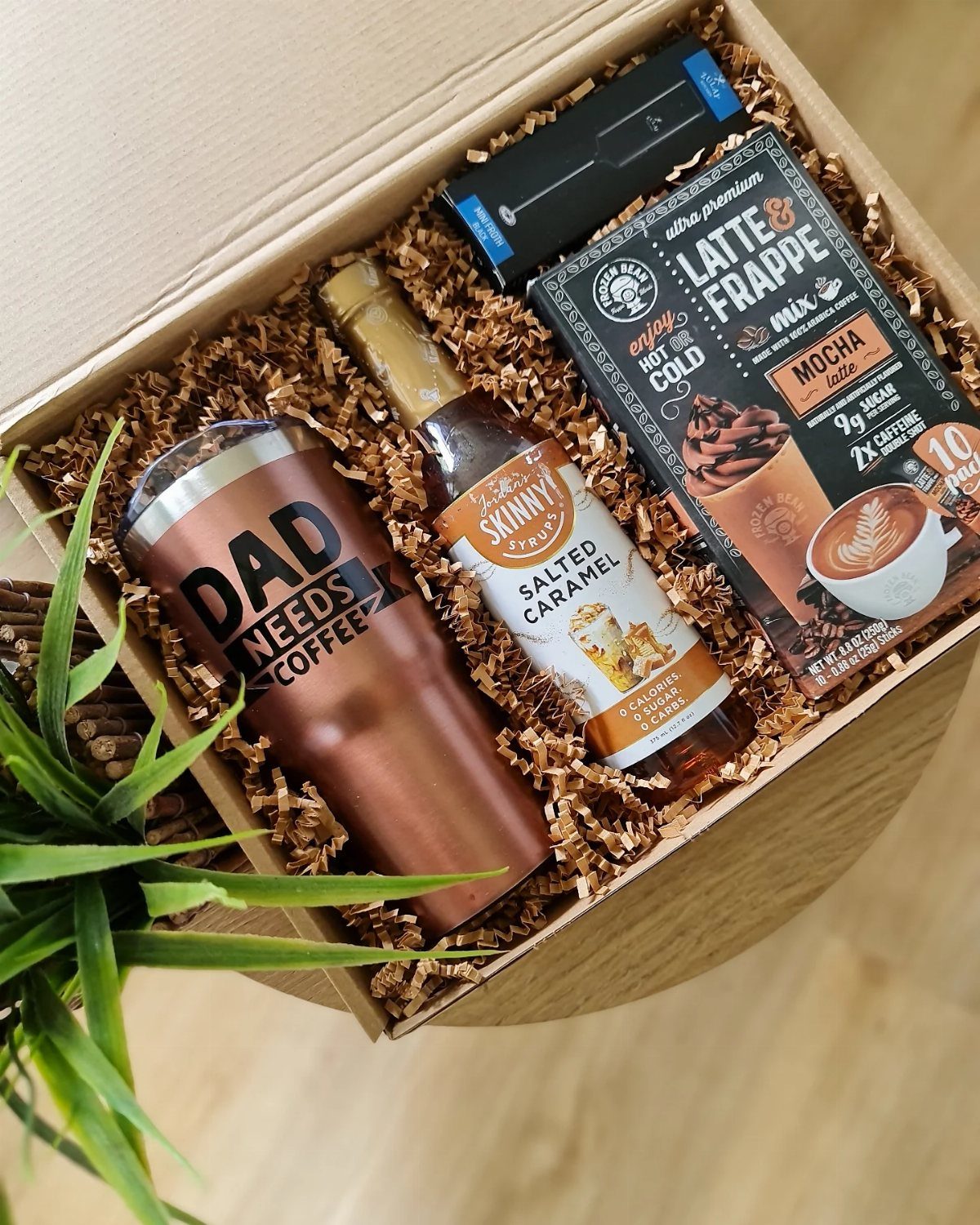Coffee gift basket with copper tumbler, salted caramel syrup, and mocha latte mix.