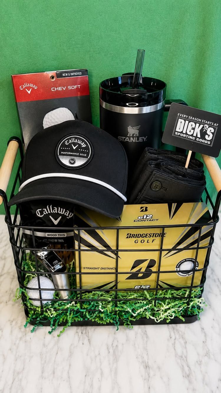 Golf themed gift basket with a black cap, tumbler, and golf balls.