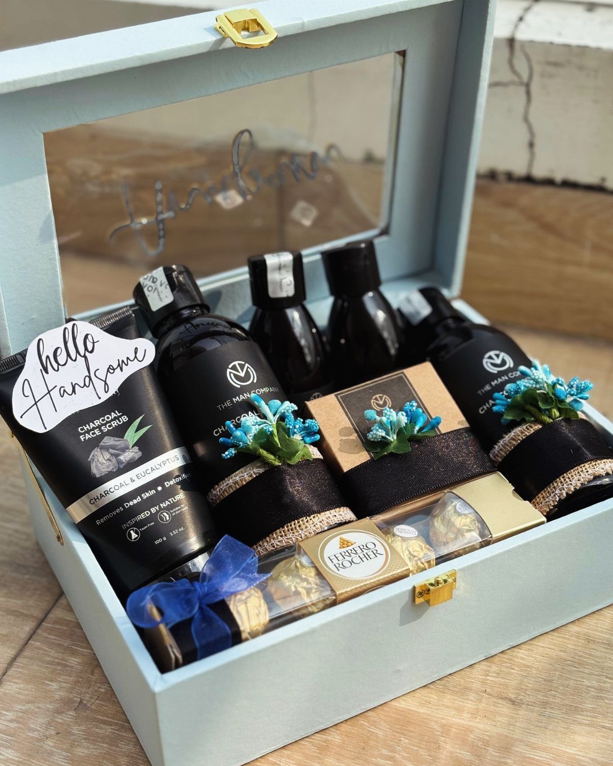 Grooming gift set in a light blue box with skincare and chocolates.
