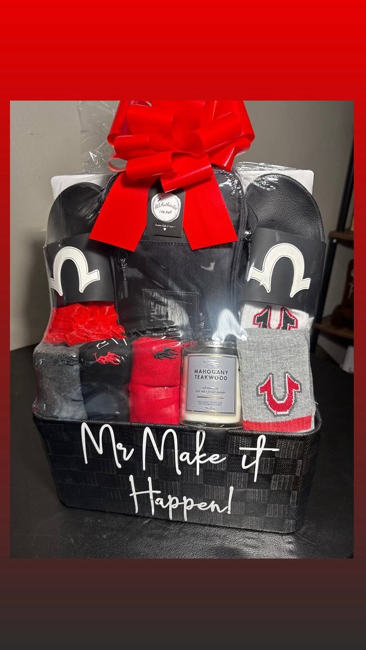 Gift basket with black slides, red and grey socks, and a scented candle.
