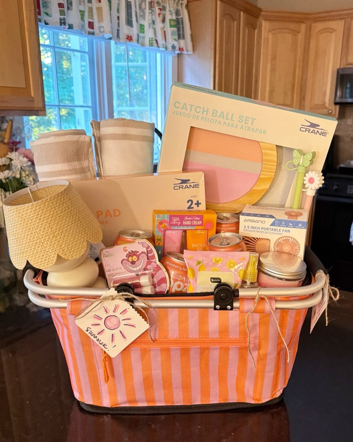 Beach getaway gift basket with striped fabric, straw hat, and beach toys.