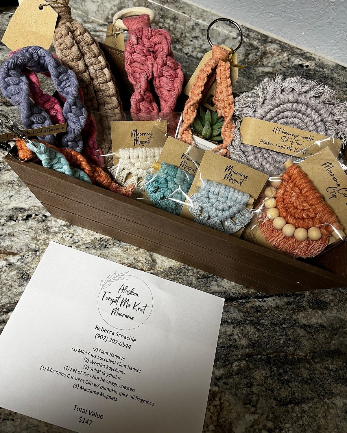 Handmade macrame coasters and keychains arranged in a wooden tray with a value list.