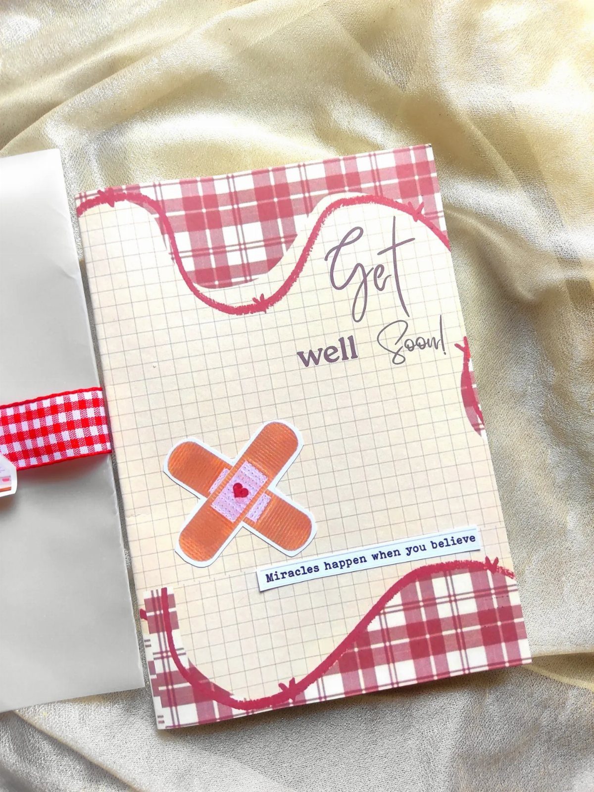 Handmade get well soon card with bandage illustration on gold fabric