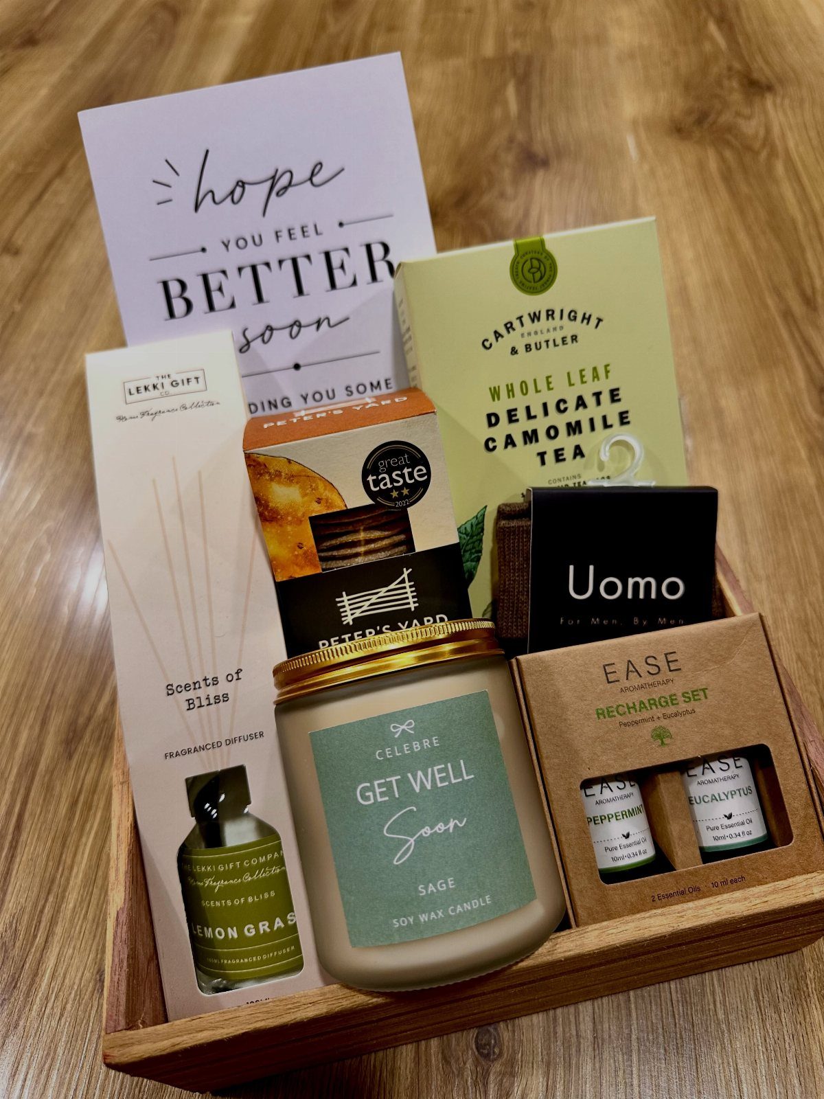 Get well gift basket with a hopeful card, scented candle, and chamomile tea.