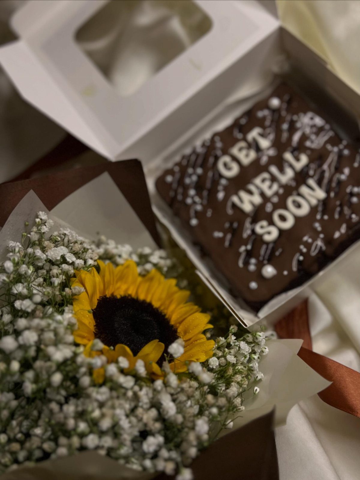 Sunflower bouquet and a chocolate brownie with Get Well Soon icing decoration