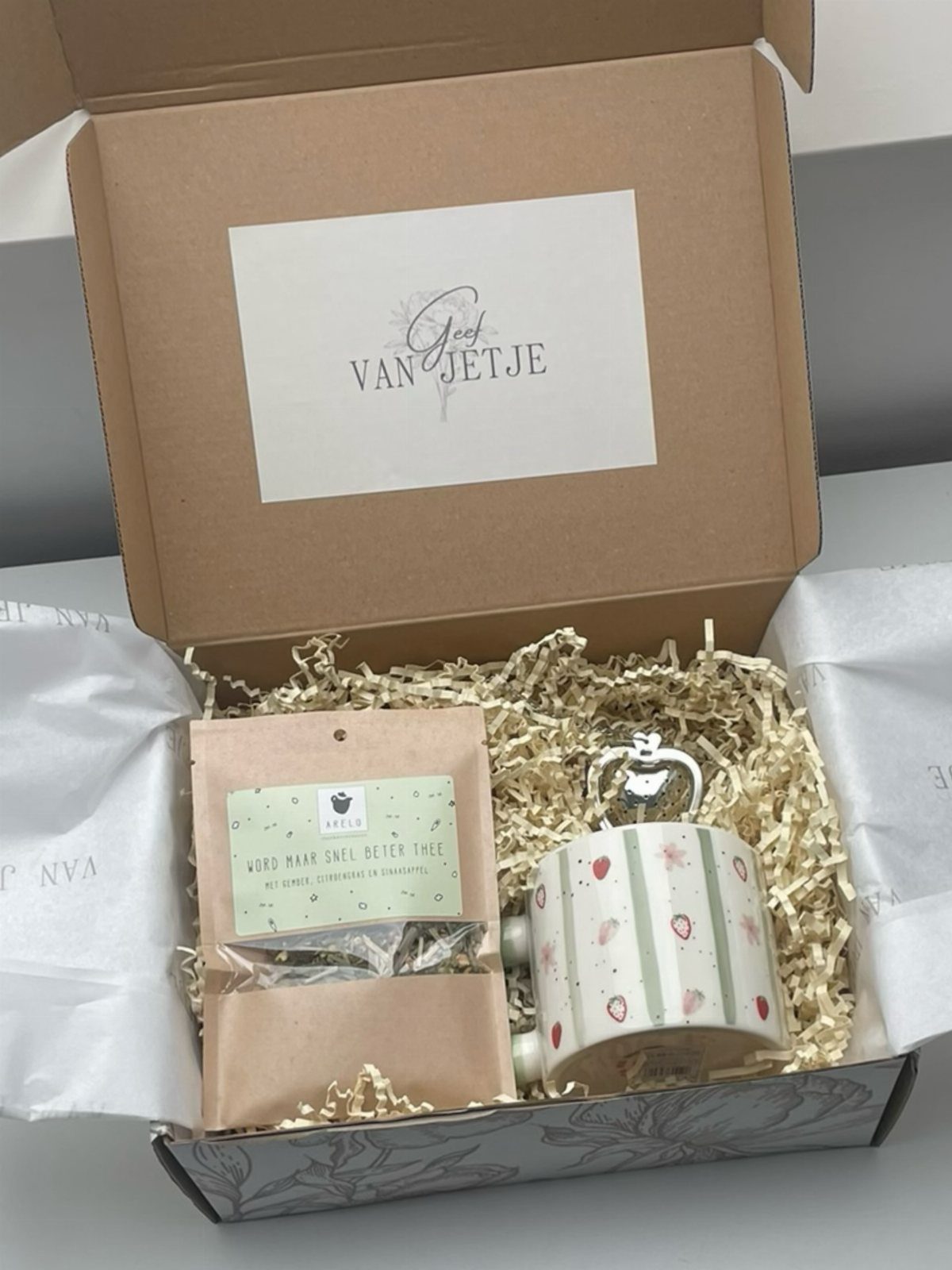Tea gift set with a floral mug and herbal tea in a box