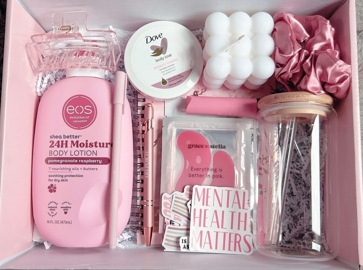 Pink gift box containing lotion, a bubble candle, scrunchie, and mental health stickers.