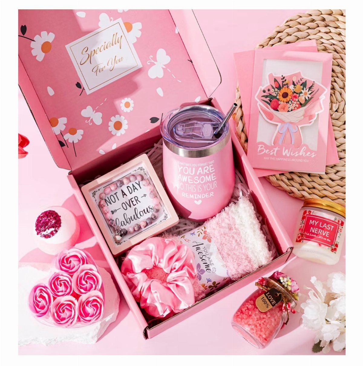 Pink spa gift box with tumbler, scrunchie, towel, soaps, and bath salts.