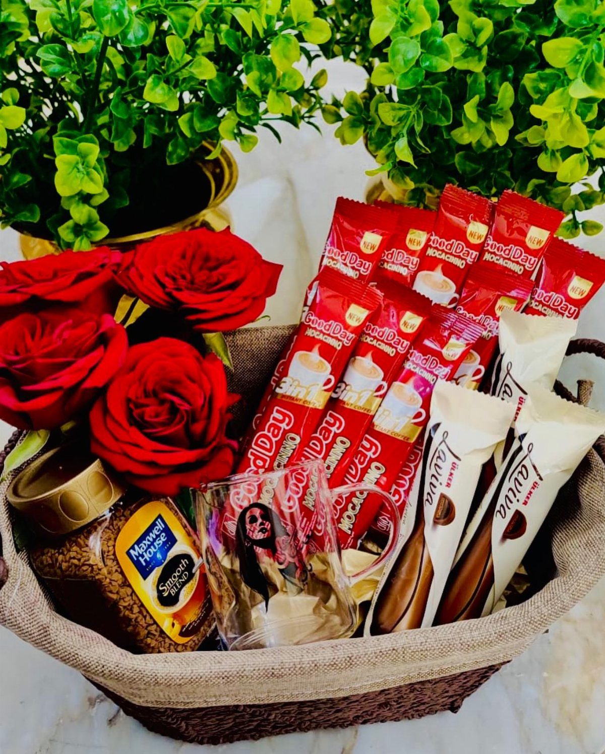 Gift basket with red roses, coffee packets, and a mug for recovery.