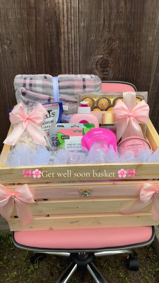 Get well soon gift basket with pink toiletries and a plaid blanket in a crate.