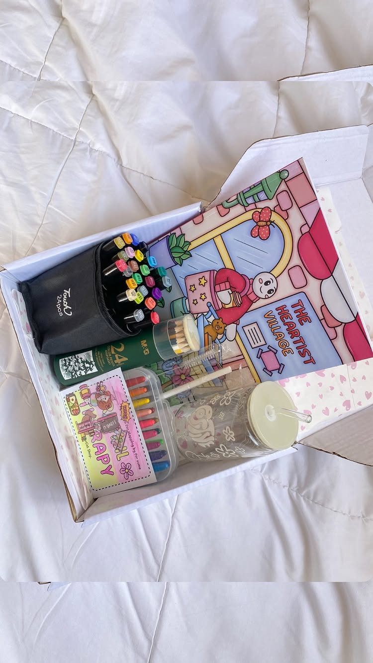 Coloring book set with markers and pencils arranged inside a white gift box.