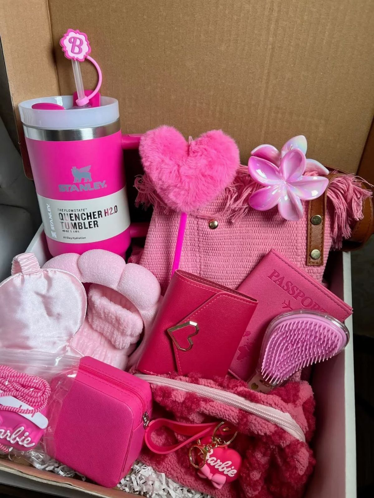 Pink themed gift box containing a Stanley tumbler, handbag, and beauty accessories.
