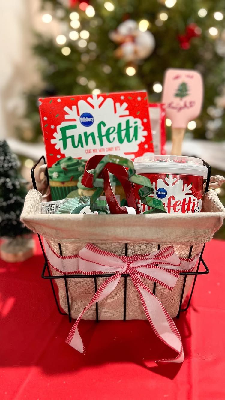 Baking gift basket with cake mix and frosting tied with a striped ribbon.