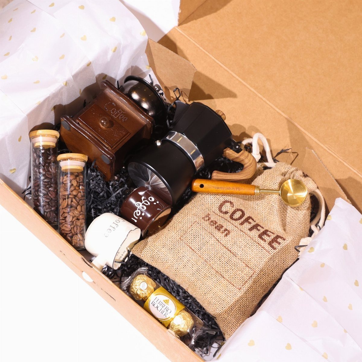 Coffee gift box containing a wooden grinder, French press, beans, and burlap bag.